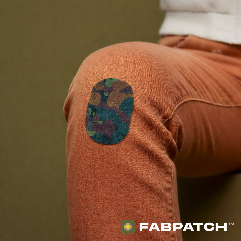 Brown pants with a camouflage patch on a green background, featuring the Fabpatch logo.